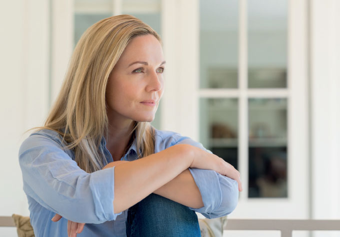 A middle-aged female looking into the distance