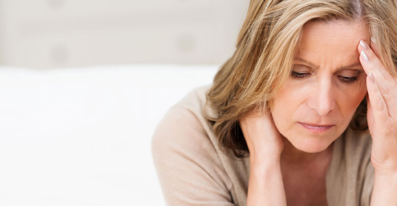 Mature lady resting her forehead